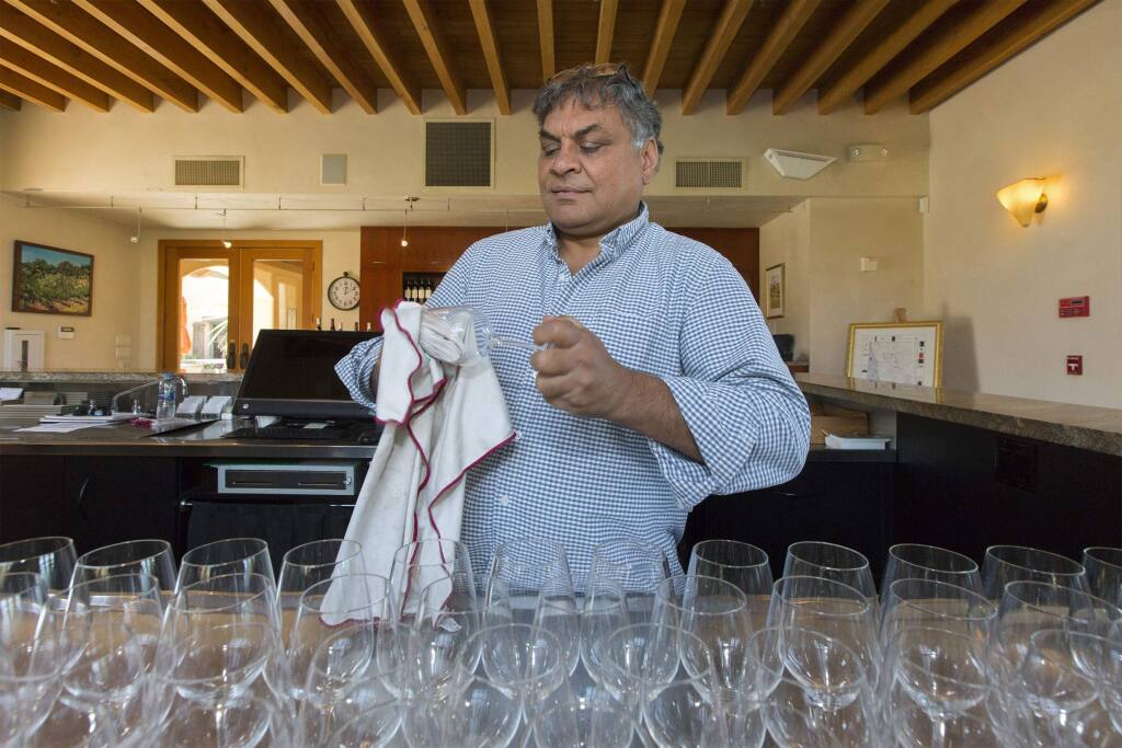 Deepak Gulrajani, owner and winemaker of the Nicholson Ranch, in the tasting room preparing for the busy holiday weekend. (Photo by Robbi Pengelly/Index-Tribune)