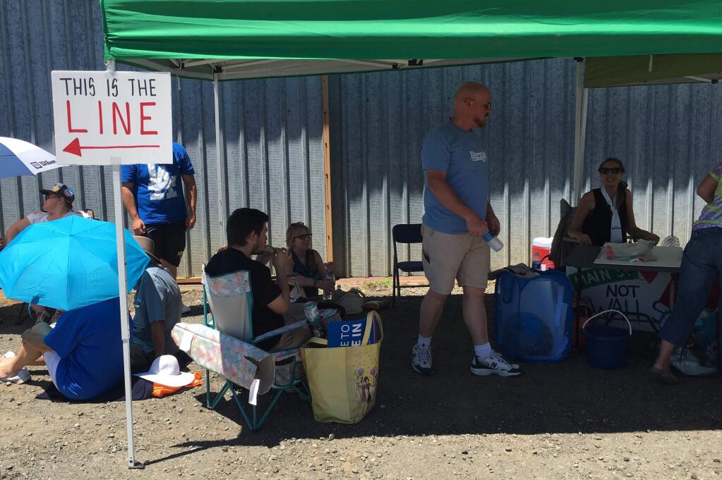Supporters of Democratic presidential candidate Sen. Bernie Sanders beat the heat in line for entrance to his rally at the Cloverdale airport on Friday, June 3, 2016. (KENT PORTER/ PD)