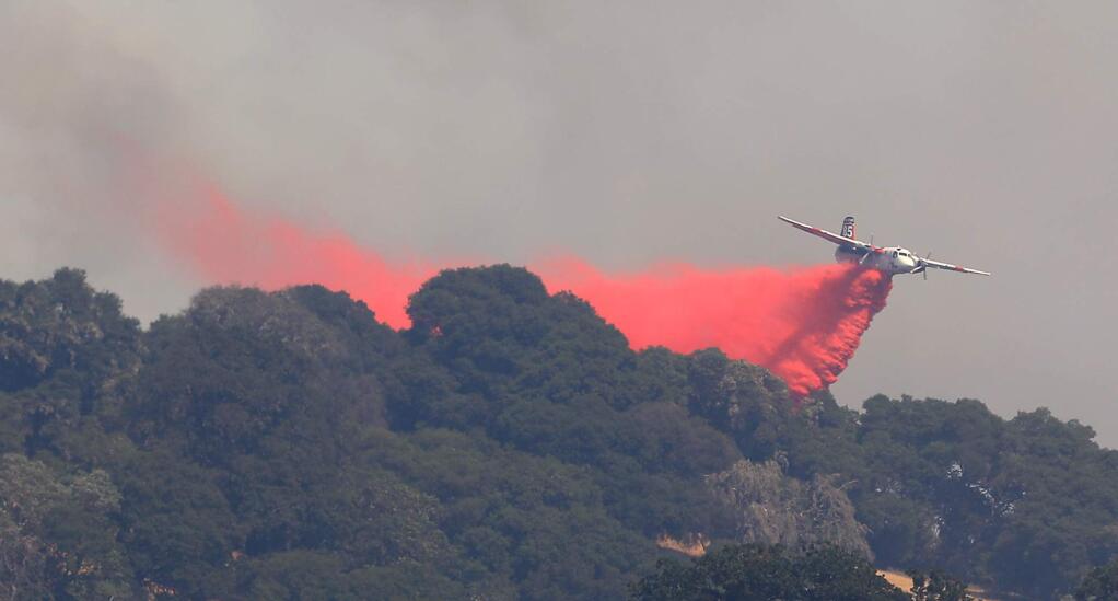 A Cal Fire tanker drops on the left flank, Friday, July 27, 2018 on the River fire in Hopland (Kent Porter / The Press Democrat) 2018