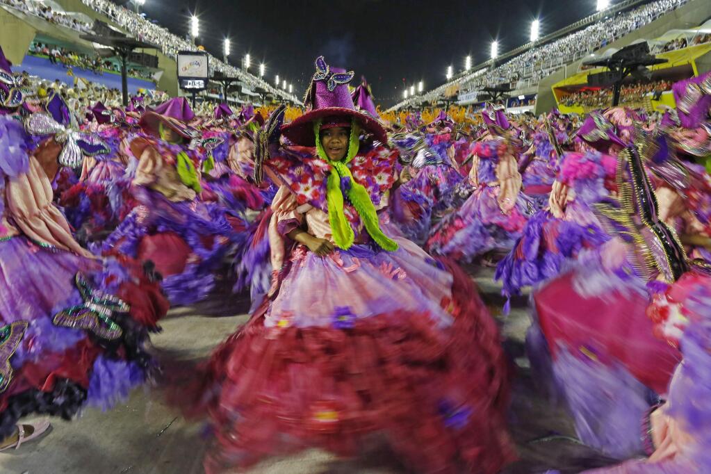 Dancers from the Mangueira samba school perform during the Carnival parade at the Sambadrome in Rio de Janeiro, Brazil, Monday, Feb. 16, 2015. (AP Photo/Leo Correa)