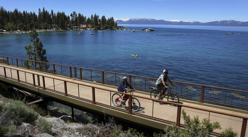 FILE - This June 25, 2019, file photo, shows cyclists riding along Lake Tahoe near Glenbrook, Nev. (Jason Bean/The Reno Gazette-Journal via AP, File)