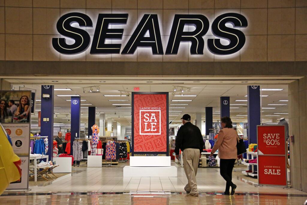 FILE - In this Wednesday, Feb. 8, 2017, file photo, shoppers walk into a Sears store in Pittsburgh. Sears said that there is “substantial doubt” that it will be able to remain in business. The company, which runs Kmart and its namesake stores, has struggled for years with weak sales. (AP Photo/Gene J. Puskar, File)