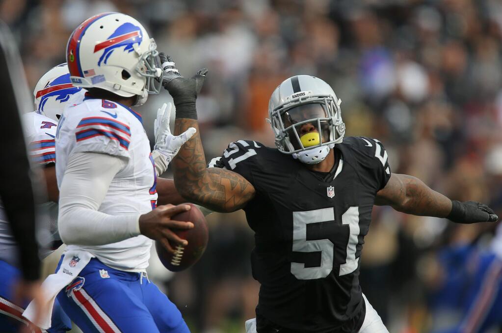 Oakland Raiders linebacker Bruce Irvin pressures Buffalo Bills quarterback Tyrod Taylor during their game in Oakland on Sunday, Dec. 4, 2016. The Raiders defeated the Bills 38-24. (Christopher Chung / The Press Democrat)