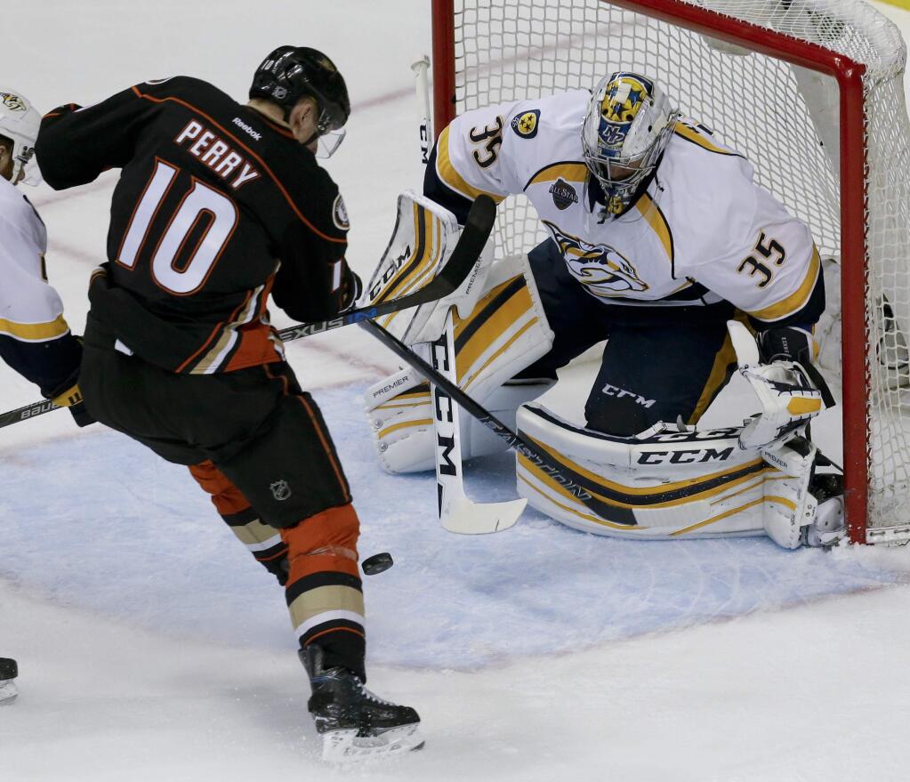 Nashville Predators goalie Pekka Rinne, right, blocks a shot by Anaheim Ducks right wing Corey Perry during the first period of Game 7 in an NHL hockey Stanley Cup playoffs first-round series in Anaheim, Calif., Wednesday, April 27, 2016. (AP Photo/Chris Carlson)