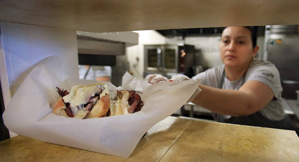 Chloe's French Café sandwich maker Anahi Cardona finishes an order, Thursday March 9, 2017 in Santa Rosa. (Kent Porter / The Press Democrat) 2017