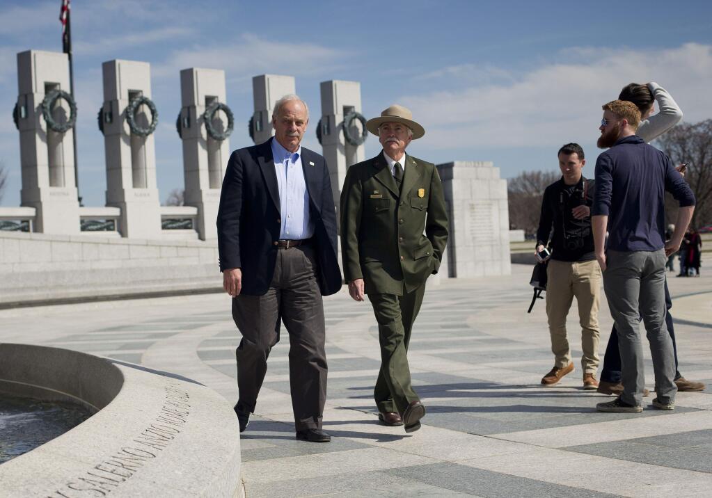 In this Monday, March 23, 2015 photo, National Park Service Director Jonathan B. Jarvis, second left, and the head of the National Park Foundation Dan Wenk, left, walk at the World War II Memorial on the National Mall in Washington. With its centennial approaching in 2016, the park service will launch a major campaign Thursday, April 2 in New York City to raise support and introduce a new, more diverse generation of millennials and children to 'America's best idea,' the national parks. (AP Photo/Pablo Martinez Monsivais)