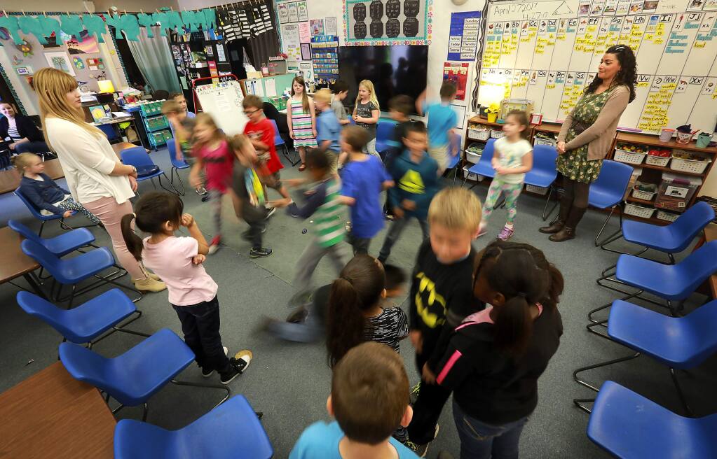 First grade students at Evergreen School in Rohnert Park play a game called 'I Love My Neighbor' during circle time in teacher Mandy Hilliard's class. (John Burgess/The Press Democrat)
