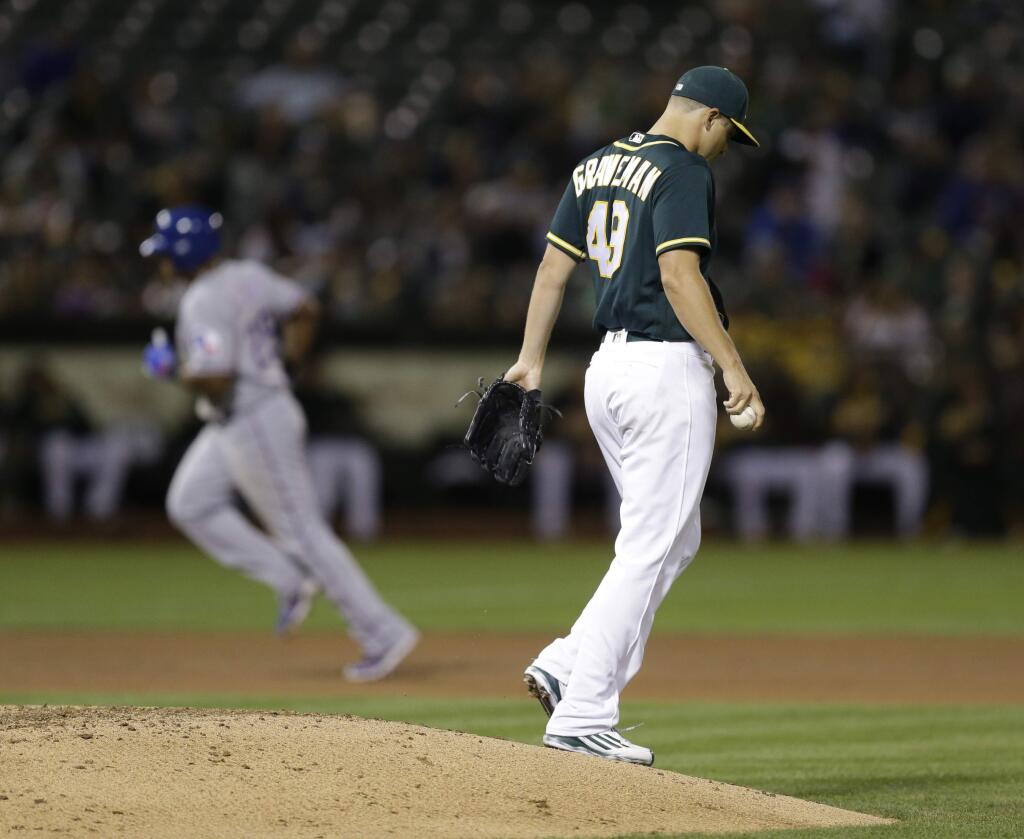 Oakland Athletics pitcher Kendall Graveman, right, walks off the mound after giving up a two-run home run to Texas Rangers' Adrian Beltre, left, in the seventh inning Friday, Sept. 23, 2016, in Oakland. (AP Photo/Ben Margot)