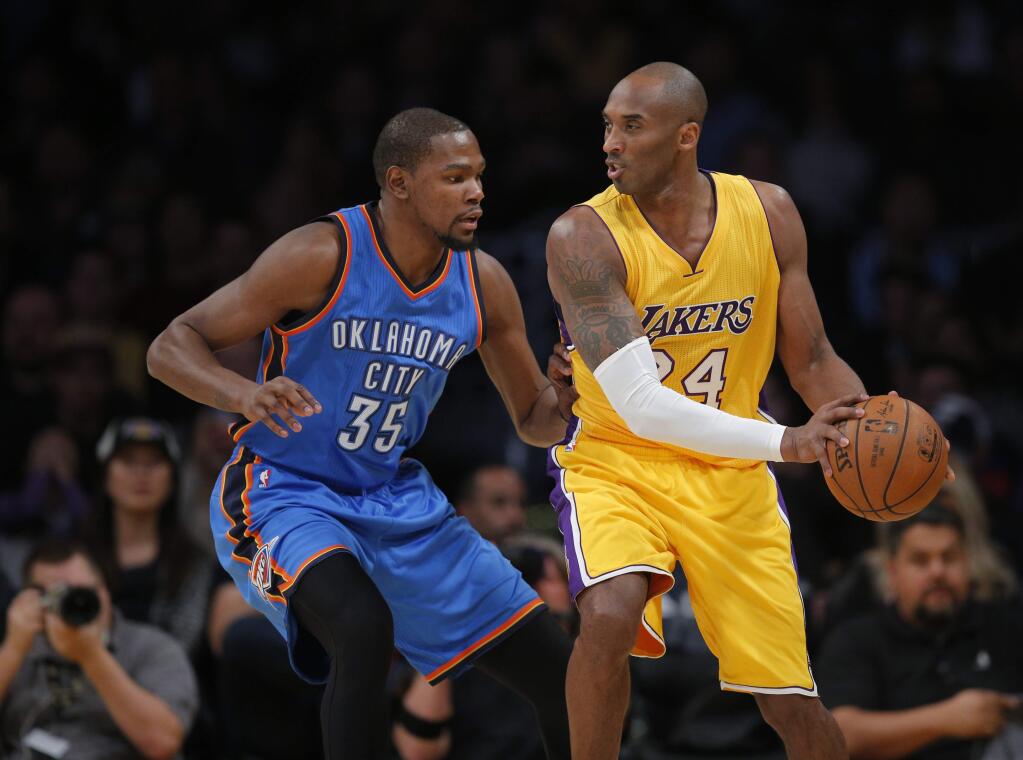 The Los Angeles Lakers' Kobe Bryant, right, is defended by then-Oklahoma City Thunder forward Kevin Durant during the first half Wednesday, Dec. 23, 2015, in Los Angeles. (AP Photo/Jae C. Hong)