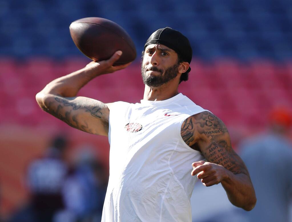 FILE--In this Aug. 20, 2016, file photo, San Francisco 49ers quarterback Colin Kaepernick passes during warmups before a preseason NFL football game against the Denver Broncos in Denver, Colo. A northern Nevada airport is getting an earful about a decorative display that, in part, highlights Kaepernick, a treasured product of the University of Nevada's football program who in recent days has been in the spotlight over his decision to sit down during the national anthem. (AP Photo/Jack Dempsey, file)
