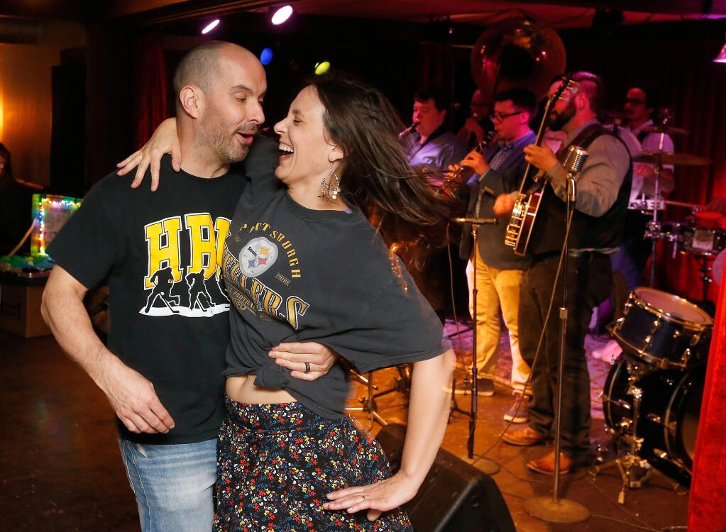 Justin and Allison Rios dance together as the Dixie Giants perform on stage during a musical benefit for UNICEF assistance to refugee Syrian children, at the Big Easy in Petaluma, California on Friday, April 14, 2017. (Alvin Jornada / The Press Democrat)