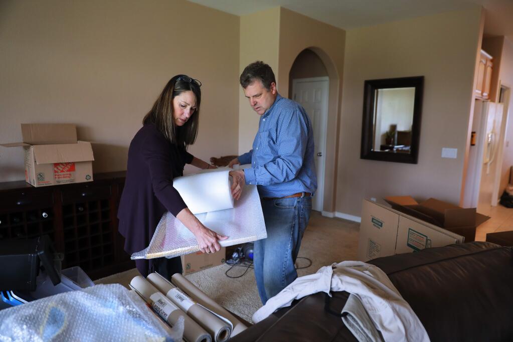 Retiring Cloverdale city manager Paul Cayler and his wife, Ellie, pack belongings in preparation for their move to Chico.(Christopher Chung/ The Press Democrat)