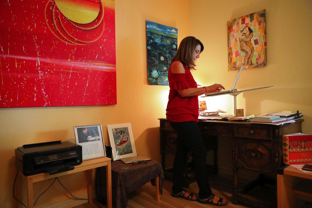 Leslie Mancillas works on writing her memoir, at the same desk that her mother used, at home in Santa Rosa on Friday, September 1, 2017. (Christopher Chung/ The Press Democrat)