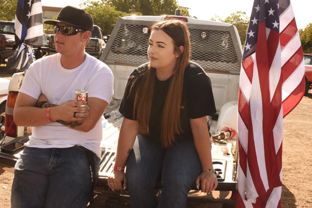 Tractor pulls fans Bryce Tutty, 21, and Taylor Short, 18, relax on a pickup truck during the West Coast Diesels 4th Annual Tractor Pulls and Show & Shine held Saturday at Sonoma County Fairgrounds in Santa Rosa, California. September 7, 2019.(Photo: Erik Castro/for The Press Democrat)