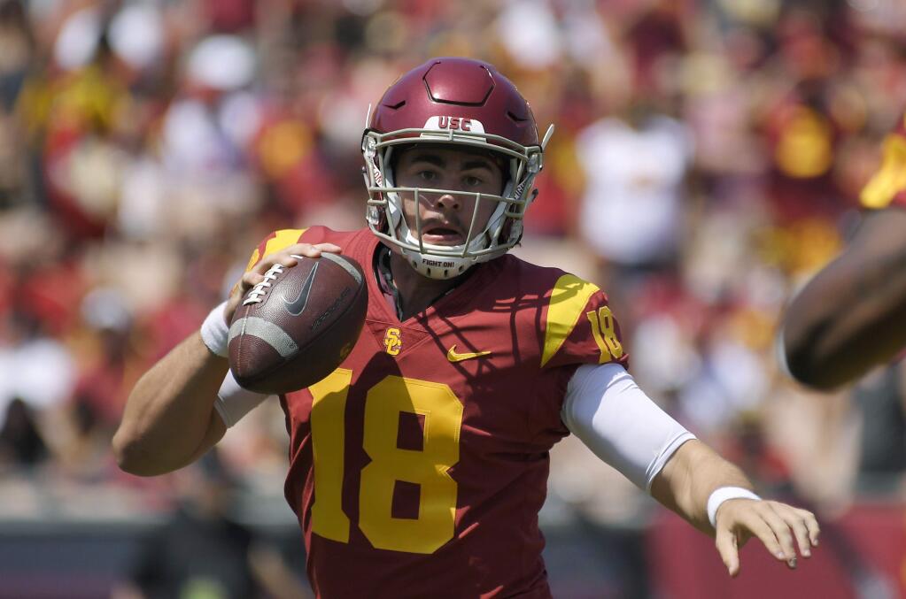 In this Sept. 1, 2018, file photo, USC quarterback JT Daniels scrambles with the ball during the first half against UNLV in Los Angeles. (AP Photo/Mark J. Terrill, File)