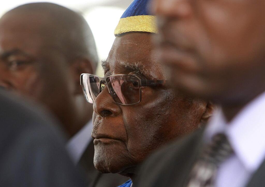 Zimbabwean President Robert Mugabe makes his first public appearance at a graduation ceremony on the outskirts of Harare, Friday, Nov. 17, 2017. Mugabe made his first appearance since the military put him under house arrest this week. (AP Photo/Tsvangirayi Mukwazhi)