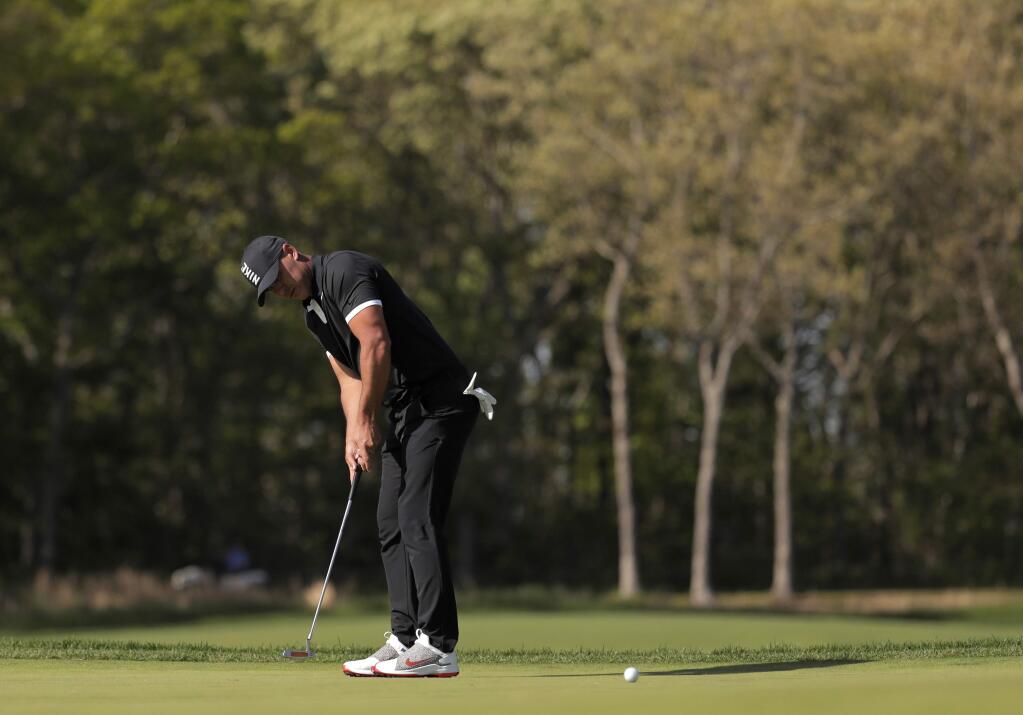 Brooks Koepka putts on the ninth green during the third round of the PGA Championship golf tournament, Saturday, May 18, 2019, at Bethpage Black in Farmingdale, N.Y. (AP Photo/Julio Cortez)