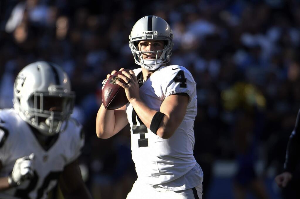 Oakland Raiders quarterback Derek Carr looks to throw a pass during the first half against the San Diego Chargers Sunday, Dec. 18, 2016, in San Diego. (AP Photo/Denis Poroy)