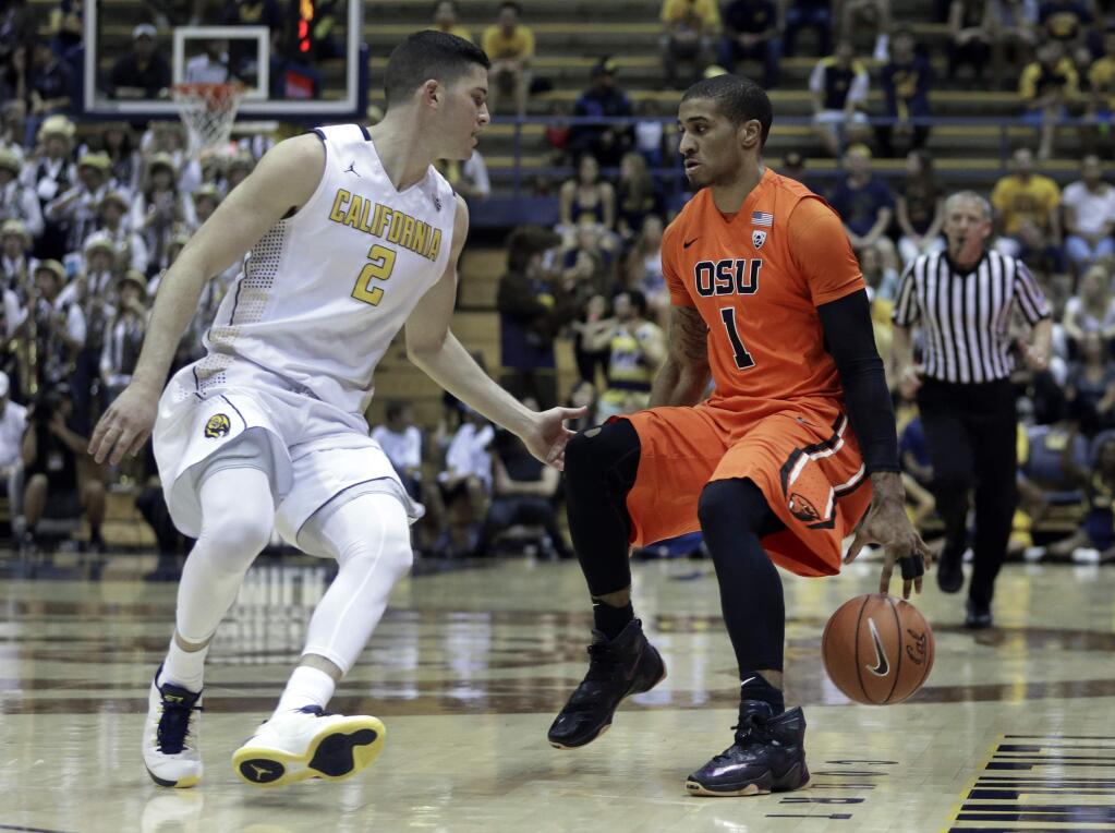 Oregon State's Maurice O'Field, right, drives the ball against California's Sam Singer in the first half Saturday, Feb. 13, 2016, in Berkeley. (AP Photo/Ben Margot)