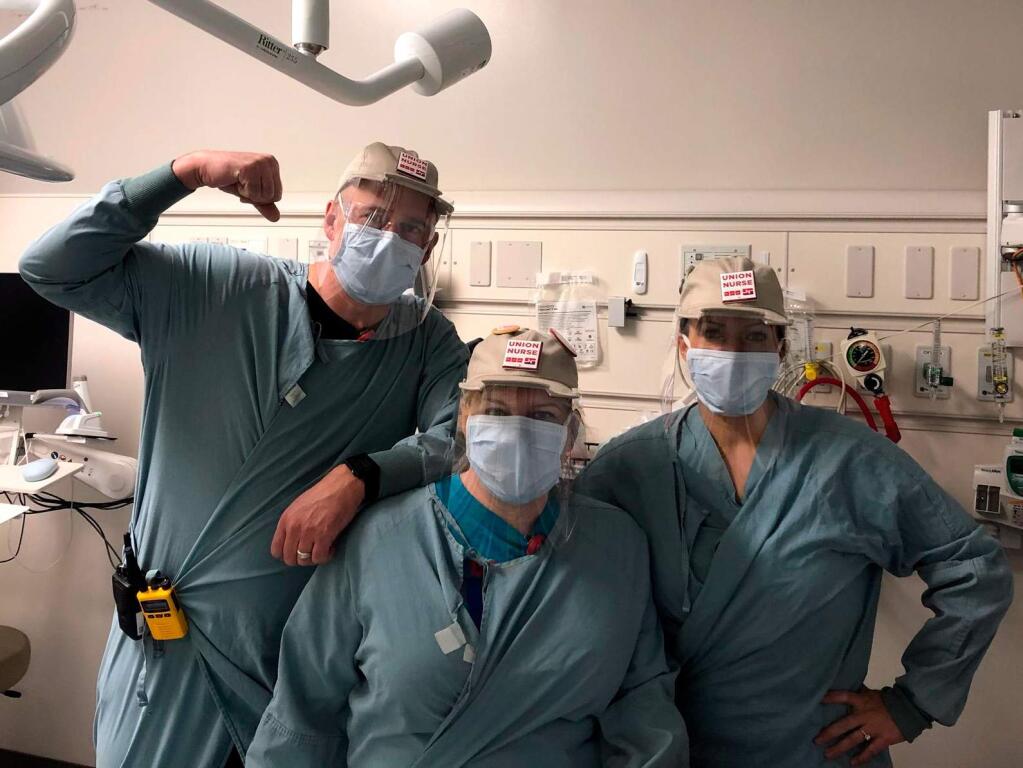 Hospital workers wear baseball cap and plastic shields made by a team led by former Autodesk CEO Carl Bass and partners such as American Canyon-based Kreysler & Associates in late March 2020. (Twitter / Carl Bass photo)