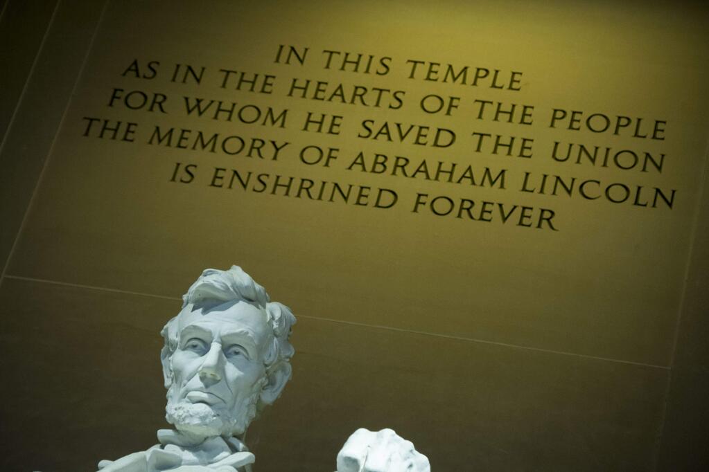 The statue of Abraham Lincoln, and quote above it, inside the Lincoln Memorial in Washington. (CLIFF OWEN / Associated Press)