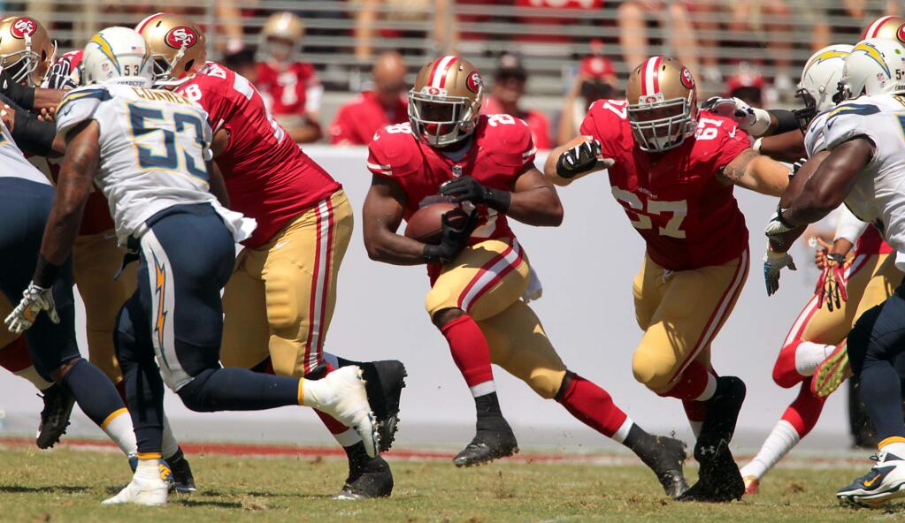 Backup running back Carlos Hyde finds a hole in the line. Hyde carried 6 times for 38 yards. The San Francisco 49ers beat the San Diego Chargers, 21-7, in a preseason game on Aug. 24, 2014. (John Burgess / The Press Democrat)