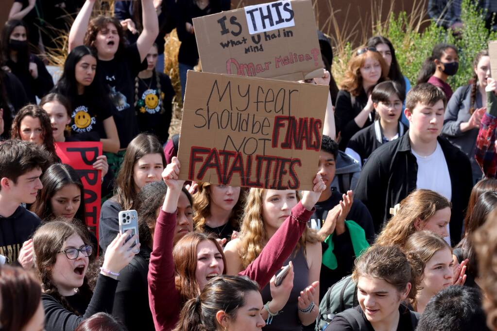 Students cheer and hold signs in the main quad after a campus walkout in protest of school safety at Maria Carrillo High School, Friday, March 3, 2023, in Santa Rosa. (Darryl Bush / For The Press Democrat)