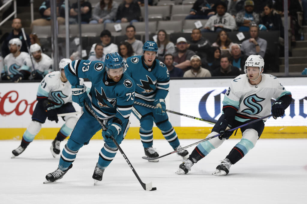 Sharks center Noah Gregor brings the puck up the ice as the Seattle Kraken’s Will Borgen defends during the first period in San Jose, Thursday, March 16, 2023. (Josie Lepe / ASSOCIATED PRESS)