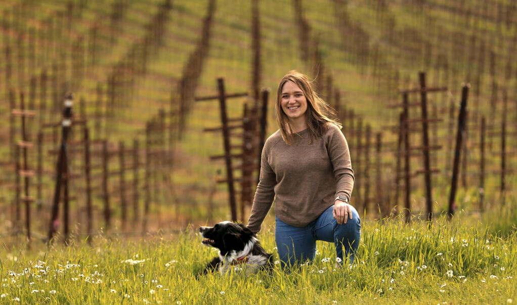 Mia Stornetta is a fifth generation Stornetta family member, Thursday, Feb. 16, 2023. Mia is a winery relations manager with Atlas Vineyard Management. She is shown with her dog, Mac. (Kent Porter / The Press Democrat)