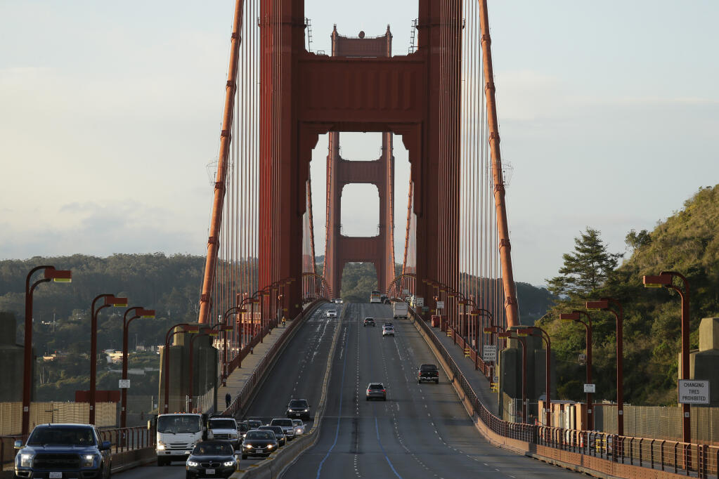 Traffic at right is light on the Golden Gate Bridge heading toward San Francisco Tuesday, March 17, 2020, in this view from Sausalito, Calif.  (AP Photo/Eric Risberg)