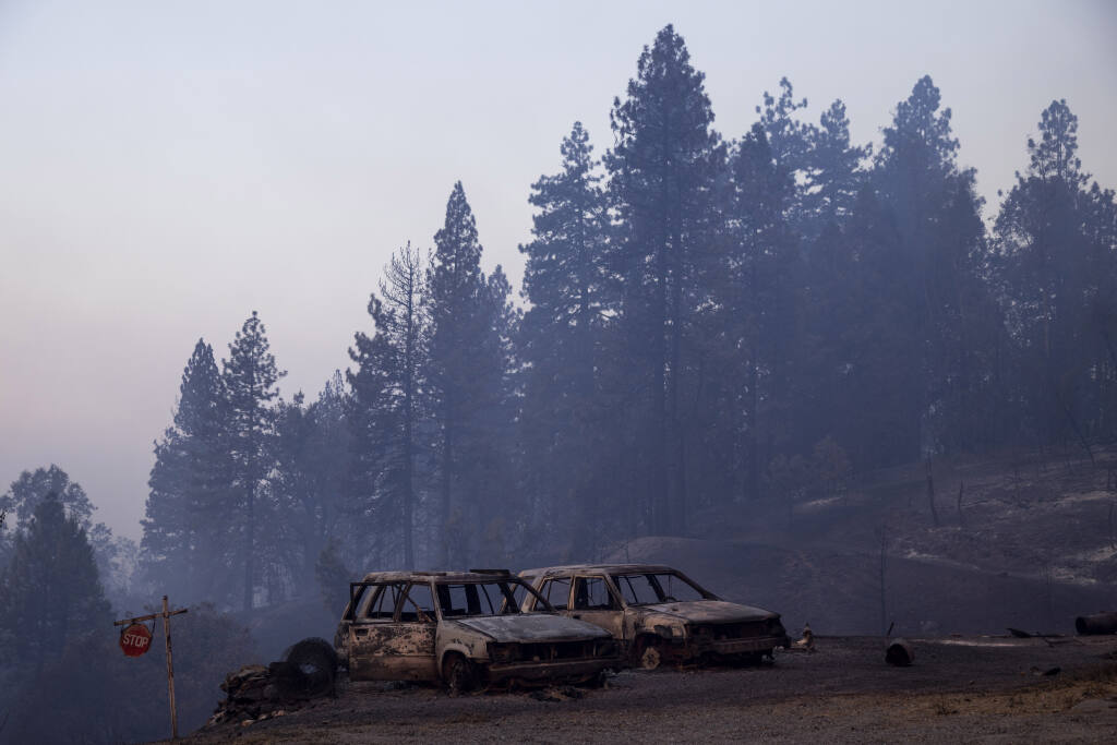 Vehicles destroyed by the Mosquito Fire are seen near Michigan Bluff in unincorporated Placer County, Calif., Thursday, Sept. 8, 2022.(Stephen Lam/San Francisco Chronicle via AP)/San Francisco Chronicle via AP)