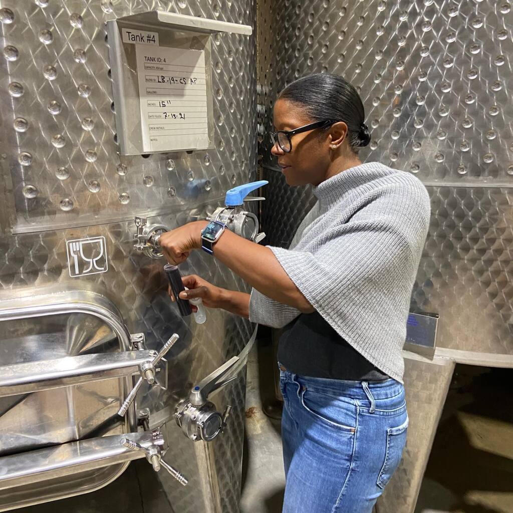 Victoria Coleman, winemaker at Lobo Wines in Napa Valley, takes a sample of cabernet sauvignon wine from a tank in the winery on July 15, 2021. (Facebook)