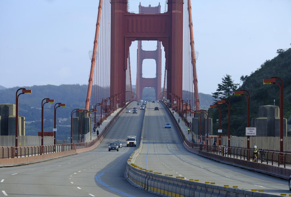 Light traffic is seen on the evening commute over the Golden Gate Bridge on Friday, March 27, 2020, in Sausalito, Calif.  (AP Photo/Eric Risberg)