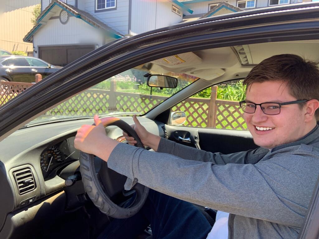 Class of 2019 Windsor High grad Landon Straub in the Saturn he obtained through a series of trades that began with him offering for swap a single blue paper clip. The blue paper clip hanging from the rear-view mirror is a second one. (Landon Straub)