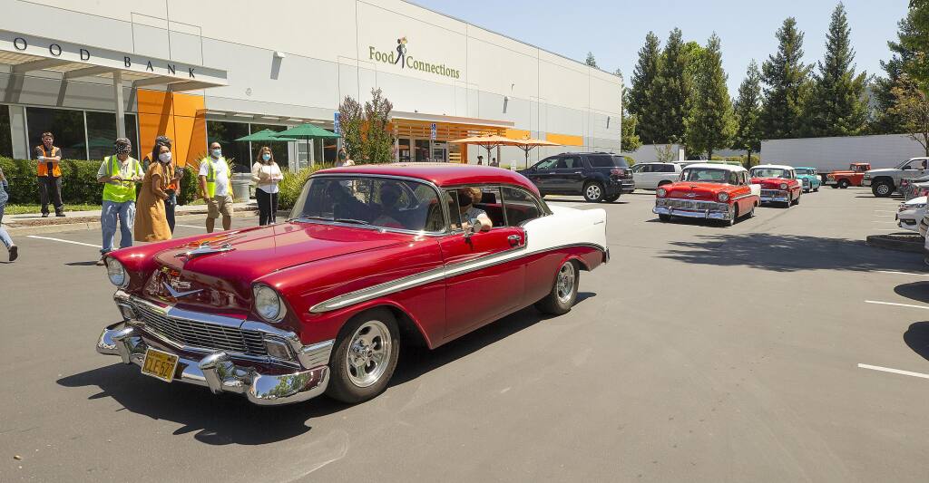 The Redwood Empire Classic Chevy Club presented a check for $1,500 to the Redwood Empire Food Bank and then entertained volunteers with a classic car parade on Wednesday, July 1, 2020. (Photo by John Burgess / The Press Democrat).