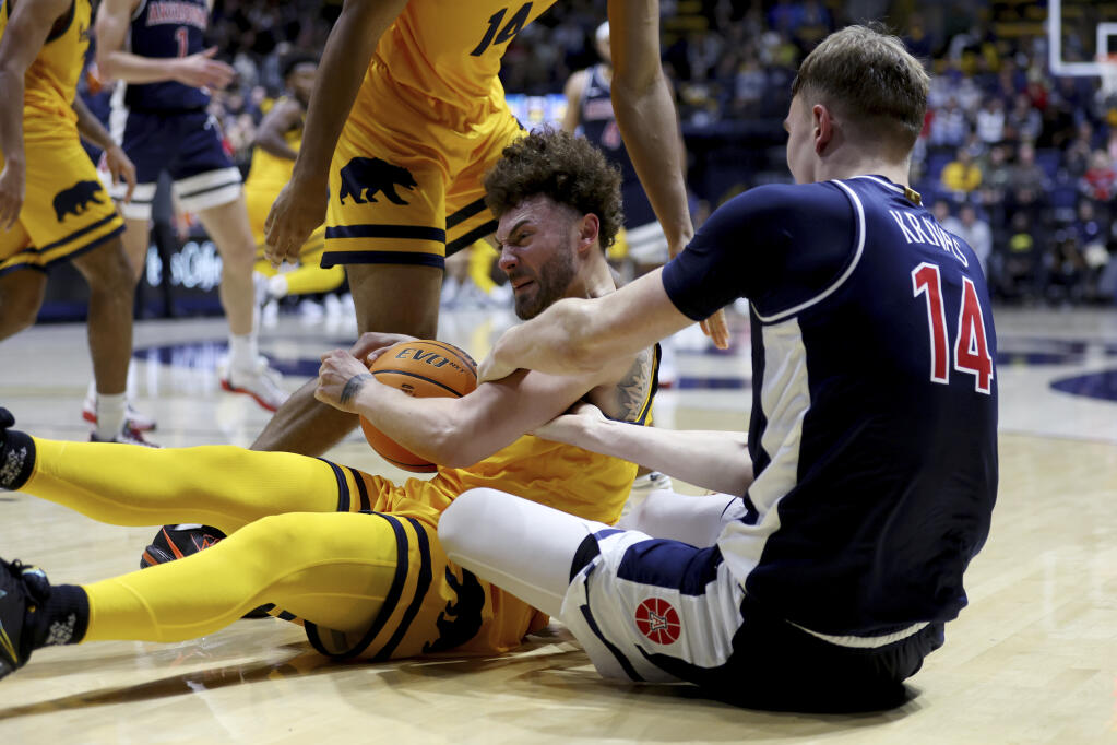 Cal guard Devin Askew, left, fights for a loose ball with Arizona center Motiejus Krivas (14) during the second half in Berkeley, Friday, Dec. 29, 2023. (Jed Jacobsohn / ASSOCIATED PRESS)