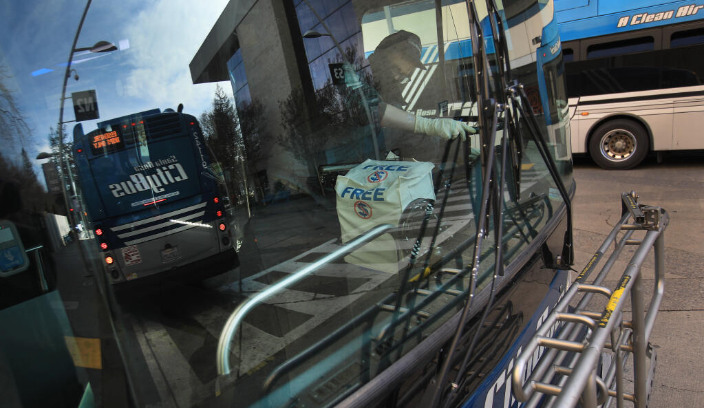 Driver prepare to continue their routes at the Santa Rosa Transit Mall on Second Street, on Thursday, Dec. 24, 2020. (Kent Porter / The Press Democrat) 2020