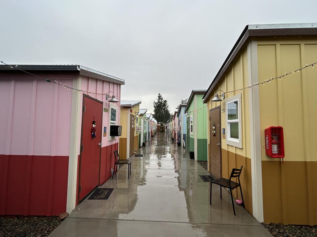 Homeless Action Sonoma held a grand opening of its Home and Safe village where 18 tiny homes line the main walkway at the property at 18820 Sonoma Highway on Sunday. (Chase Hunter)
