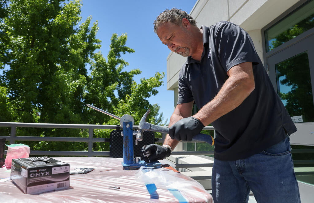 Matt Gutwill, a trainer with Noble, demonstrates how easily pills can be made with a simple press at the Rohnert Park Department of Public Safety building in Rohnert Park on Tuesday, June 28, 2022.  (Christopher Chung/The Press Democrat)