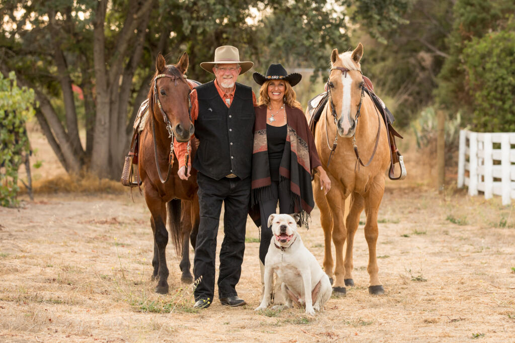 Joel and Sahar Bartlett pose with their horses and dog Bentley at their Santa Rosa ranch. The Bartletts purchased the property in 2012 and spent the last decade making improvements to it. (Hannah Beebe)