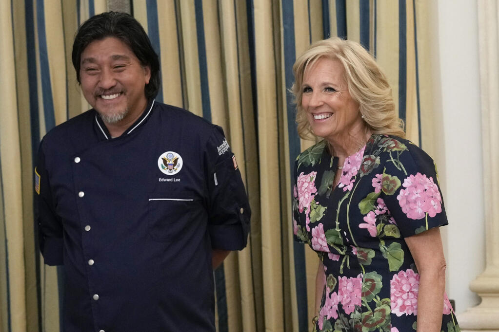 Guest Chef Edward Lee, left, and first lady Jill Biden, right, laugh during a media preview, Monday, April 24, 2023, for Wednesday's State Dinner with South Korea's President Yoon Suk Yeol at the White House in Washington. (AP Photo/Susan Walsh)