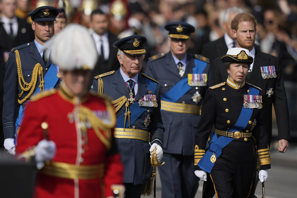 King Charles III, center left, Princess Anne , second right, Prince Harry, right, and Prince William, left, follow the coffin of Queen Elizabeth II during a procession from Buckingham Palace to Westminster Hall in London, Wednesday, Sept. 14, 2022. The Queen will lie in state in Westminster Hall for four full days before her funeral on Monday Sept. 19. (AP Photo/Frank Augstein, Pool)