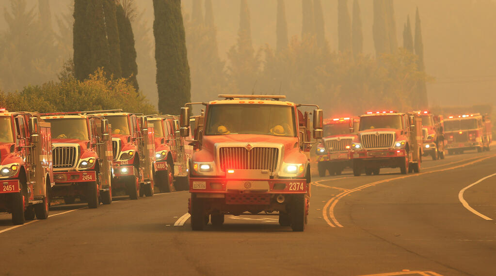 Strike teams of firefighters stage on Silverado Trail, Sunday, Sept. 27, 2020 to help with the Glass fire incident.  (Kent Porter / The Press Democrat) 2020