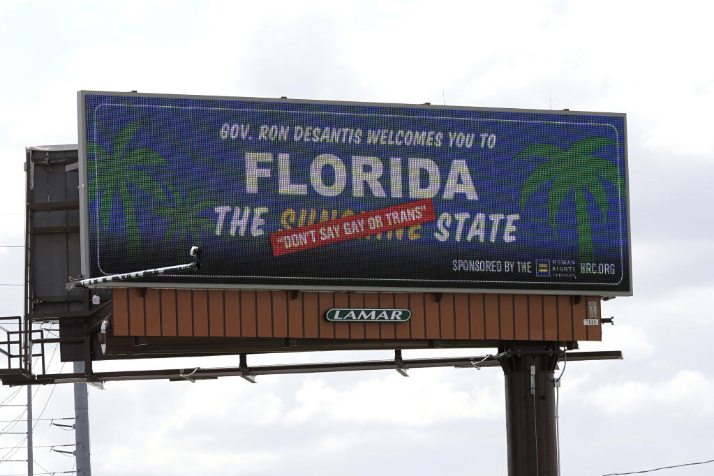 FILE - A new billboard welcoming visitors to "Florida: The Sunshine 'Don't Say Gay or Trans' State," is seen on April 21, 2022, in Orlando, Fla. (AP Photo/John Raoux, File)