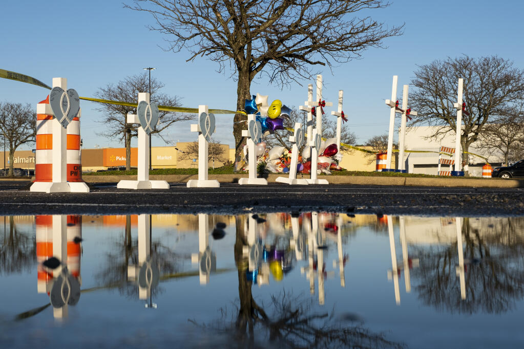 Crosses were set up at a memorial on Friday, Nov. 25, 2022 , for the six killed in a Chesapeake, Va., Walmart mass shooting earlier in the week. (Billy Schuerman/The Virginian-Pilot via AP)