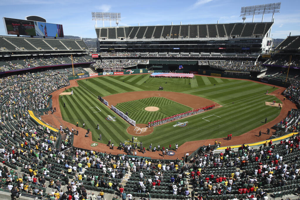 The Los Angeles Angels and Oakland Athletics stand for the national anthem at the Oakland Coliseum on opening day in 2018. (Ben Margot / ASSOCIATED PRESS)