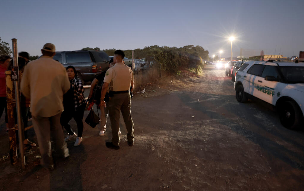 Sonoma County Sheriff’s deputies talk with possible witnesses after a fight between suspected rival gang members Friday, Aug. 26, 2022, outside the football field at Windsor High School. (Kent Porter / The Press Democrat)