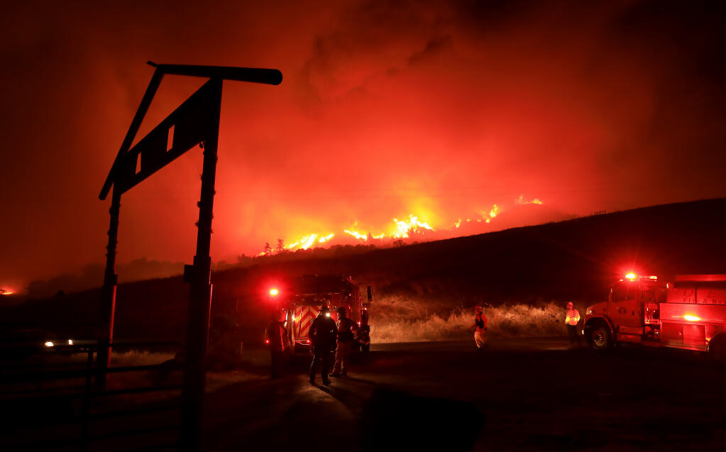 Firefighters prepare to defend their ground as the Kincade fire marches down Black Mountain toward Hawkeye Ranch in the Geysers, Thursday, Oct. 24, 2019. in Sonoma County. (Kent Porter / The Press Democrat)