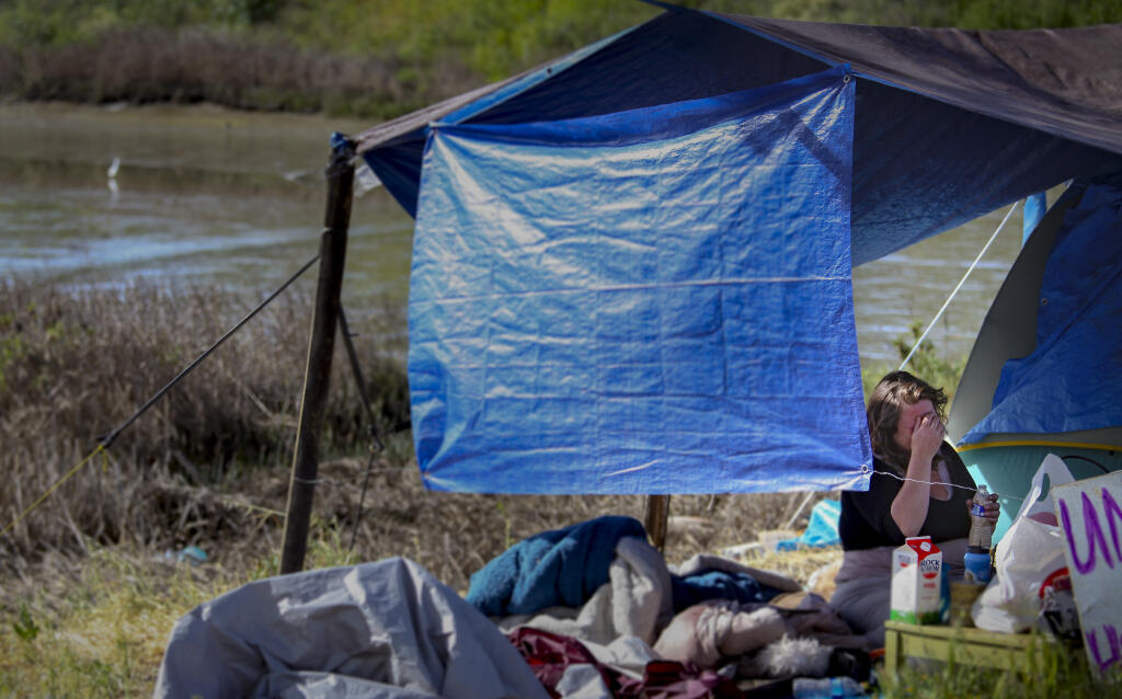 Worrying about where they will go next, Sarah Gossage cries in the tent she and her boyfriend, Mark vanDerVen, set up next to the Petaluma River in this April 2021 Argus-Courier file photo. (CRISSY PASCUAL/ARGUS-COURIER STAFF)