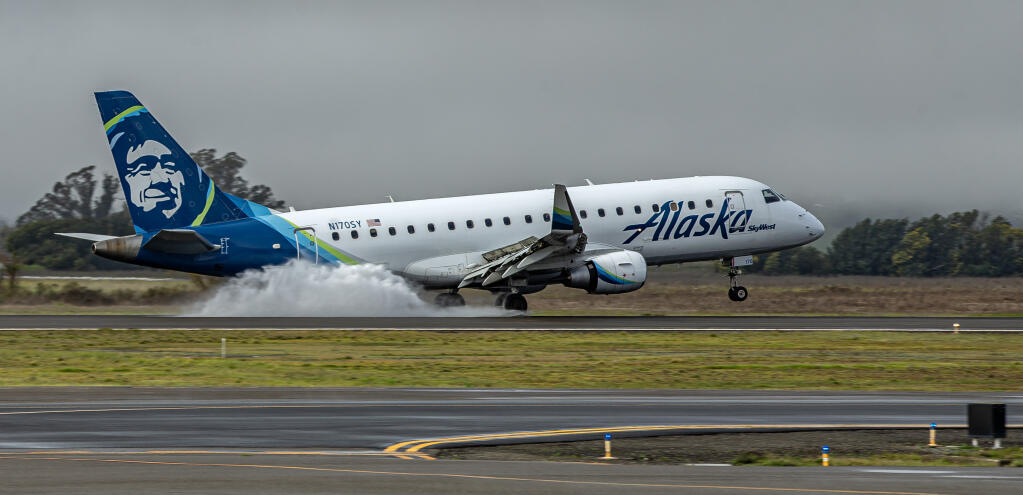 Alaska Airlines flight 3316 from San Diego applies the brakes while landing on a wet Runway 32 in foggy, rainy conditions at Charles M. Schulz-Sonoma County Airport Thursday, Feb. 15, 2024. (Chad Surmick / The Press Democrat)